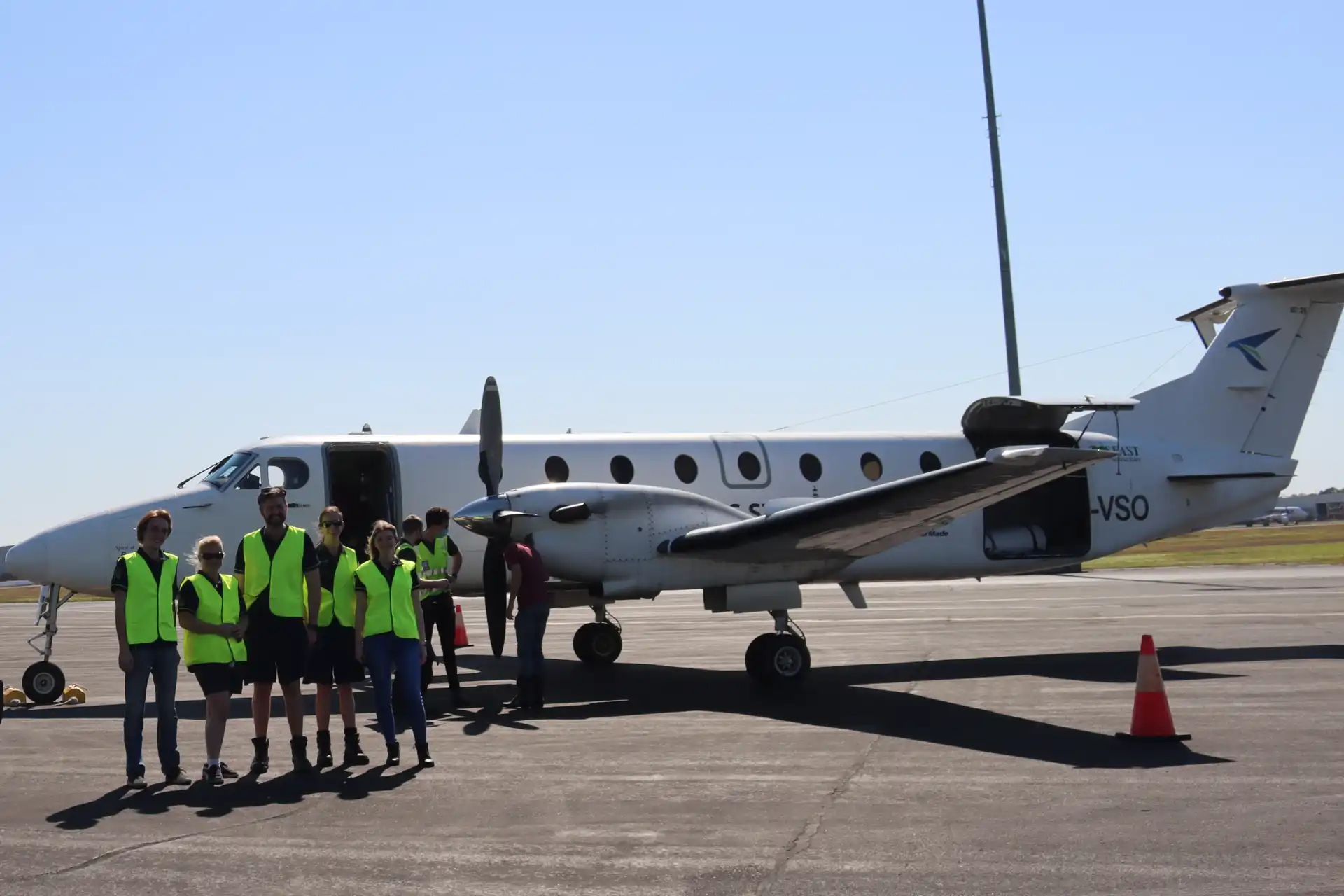 team-members-in-front-of-plane